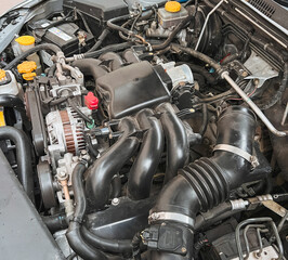 Fototapeta na wymiar Engine bay with opposed 6 cylinder boxer engine. Service maintenance and repair.