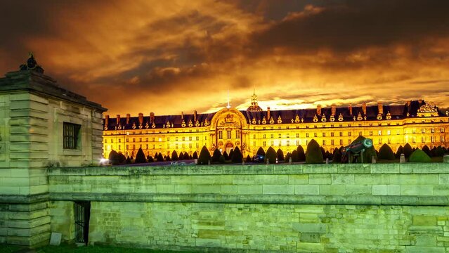 Les Invalides (The National Residence of the Invalids) against the background of the sunset (4K, time lapse, with zoom). Paris, France