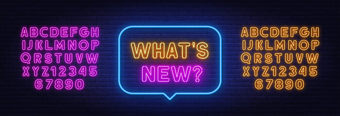 What s New neon sign in the speech bubble on brick wall background.