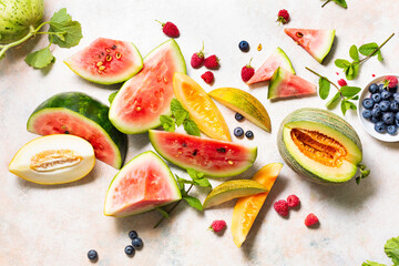 Different types of tasty ripe watermelon and melons with berry. Top view.