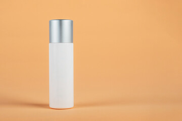 Cosmetic product in tube, bottle, lotion or serum seed on cream background. 