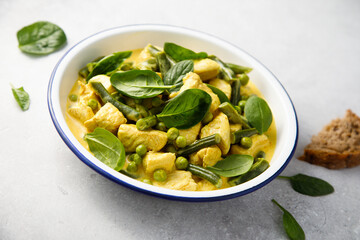 Homemade chicken curry with spinach and pea