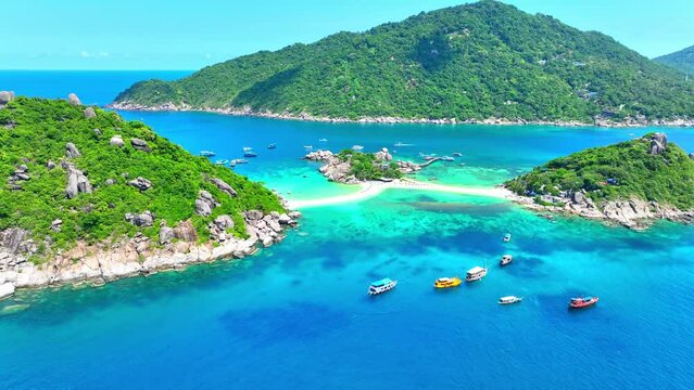 Koh Nangyuan is a picturesque trio of islands connected by sandbars, offering unparalleled beauty and serenity. Flight over the sea. Koh Nangyuan, Surat Thani Province, Southern Thailand. 4K UHD.
