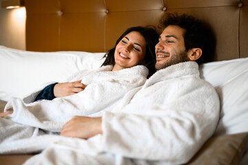 Laughing couple relaxing in bed