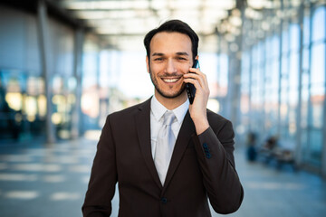 Smiling businessman on a phone call