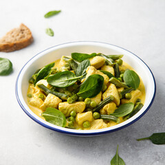 Homemade chicken curry with spinach and pea
