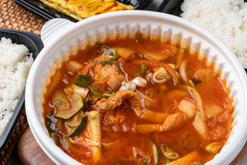 Korean food, kimchi stew, ham, soft tofu, pork, egg roll, rice, side dishes