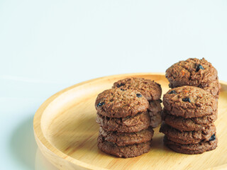 Delicious chocolate cookies on a wooden plate     