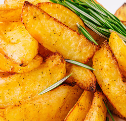 Baked potato wedges with rosemary close up