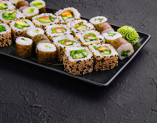 vegetarian sushi rolls on black plate