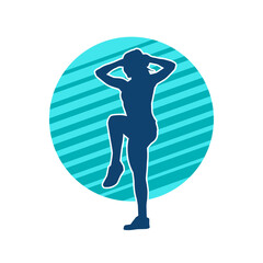 Silhouette of a slim sporty woman doing pilates exercise. Silhouette of a sporty female doing physical exercise. 