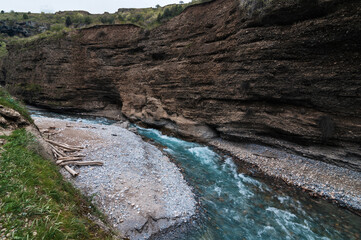 blue water in the river in the mountains in the Aksu canyon in Kazakhstan in spring
