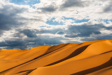 Dramatic sunset over the sand dunes in the desert. Gobi desert