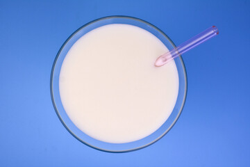 Glass of milk on a blue background.Flat lei.
