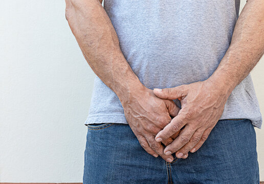 Man's hand holding his urethra in pain clenched Prostate cancer, enlarged prostate, urethritis, health care concept