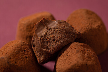 truffle candies piled on a purple background