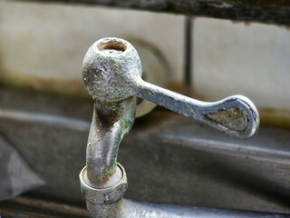 Close up of the old rusty faucet on the kitchen counter.