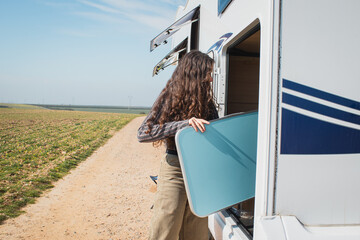 young woman storing the motorhome furniture.