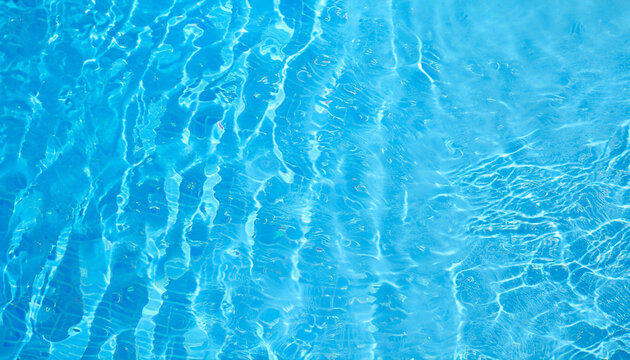 Water background. Blue water texture, surface of blue swimming pool. Spa concept background. Flat lay, top view, copy space