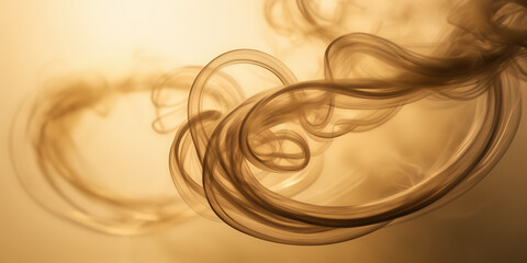 Close-up photograph of swirling tendrils of smoke illuminated by soft, golden light against a neutral background.