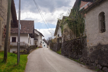 Fototapeta na wymiar A street in the historic mountain village of Luint in Carnia in Udine Province, Friuli-Venezia Giulia, north east Italy