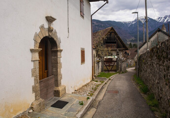 Fototapeta na wymiar A street in the historic mountain village of Luint in Carnia in Udine Province, Friuli-Venezia Giulia, north east Italy