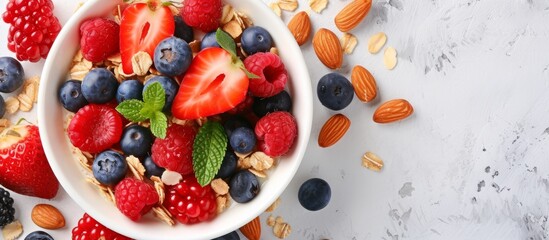 A variety of fresh fruits and nuts in a bowl on a clean white surface - obrazy, fototapety, plakaty