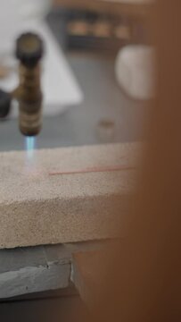 Professional Jeweler Using Blow Torch Melting A Piece Of Metal. Selective Focus Shot