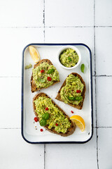Mashed avocado on toast with lemon and chili pepper
