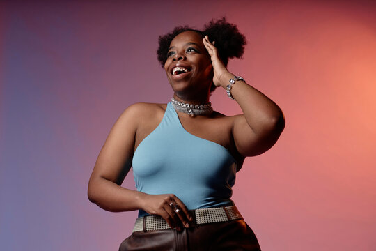 Happy woman wearing blue top against gradient background