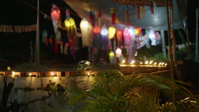 Colorful lanterns sway at night in Sri Lankan temple, Vesak fest lights glimmer. Spirituality, culture blend vibrant decor. Buddhist beliefs, peace resonate sacred place, worshippers gather, reflect.