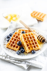 Sweet and very tasty waffles with honey and blueberries - 746434677