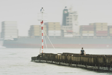 Aerial view of a large container cargo vessel ship sailing along the Dutch coast near Vlissingen