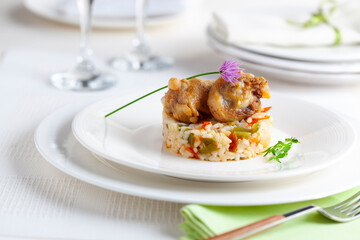 Rice dish with chicken, vegetables and garlic flower