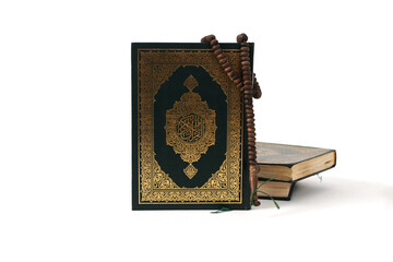 The Holy Quran with Arabic calligraphy, meaning The Noble Quran, and a tasbih, isolated on a white background