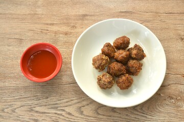 fried salt crispy chop pork with garlic dipping chili sauce on plate 