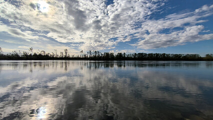 blue sky and white clouds reflected in Danube river in Vojvodina