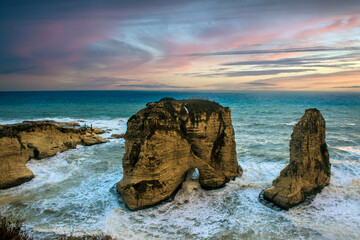 Magical sunset over Pigeon Rocks iconic natural landmark at seaside, Raouché, Beirut, Lebanon