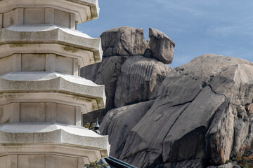 View of the stone pagoda against a huge rock