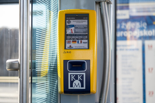 MPK Krak&oacute;w validation ticket machine, with KKM Krakowska Karta Miejska Cracow City Card logo sign. Electronic validator for public transport bus or tram tickets on February 25, 2024 in Krakow, Poland.
