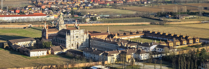 Fototapeta na wymiar Aerial shot over Certosa di Pavia monastery with lawn fields in Italy, Pavia