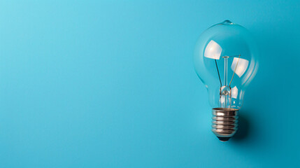 Close up of light bulb on blue background. Copy space. - obrazy, fototapety, plakaty