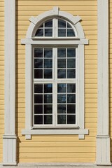 Window on a yellow painted building.