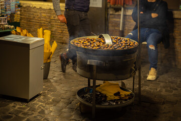 people selling bakked chestnut on the street in Rome, Italy