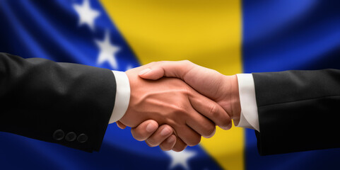 Businessman and diplomat in suits clasp hands for handshake over Bosnia and Herzegovina flag, agree on united success in trade, diplomacy, cooperation or negotiation, gesture of greeting