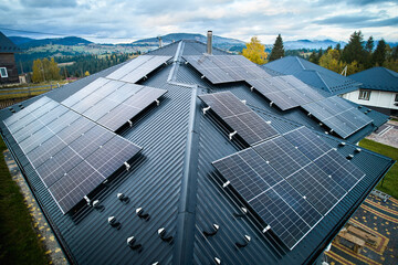 Photovoltaic solar panel system on the roof of house. Modern solar modules installed on house....