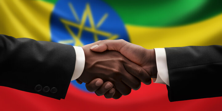 Businessman, diplomat in suits clasp hands for handshake over Ethiopia flag, agree on united success in trade, diplomacy, cooperation, negotiation, support, teamwork in commerce, gesture of greeting