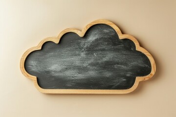 Blackboard in the shape of a cloud, concept of creativity, learning, beige background.