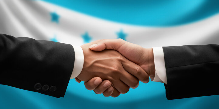 Businessman, diplomat in suits clasp hands for handshake over Honduras flag, agree on united success in trade, diplomacy, cooperation, negotiation, support, teamwork in commerce, gesture of greeting
