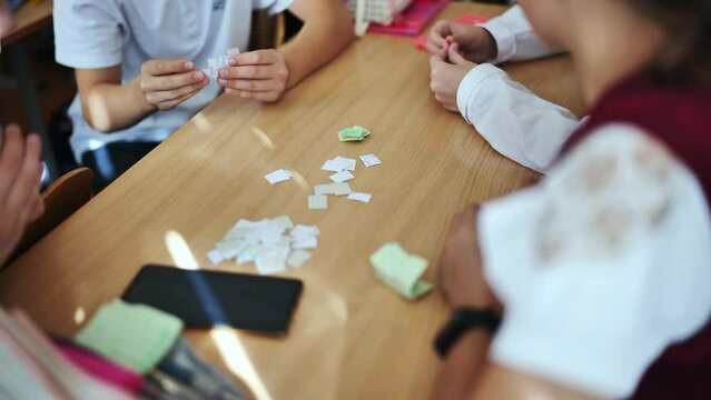 Children play with homemade small papers.